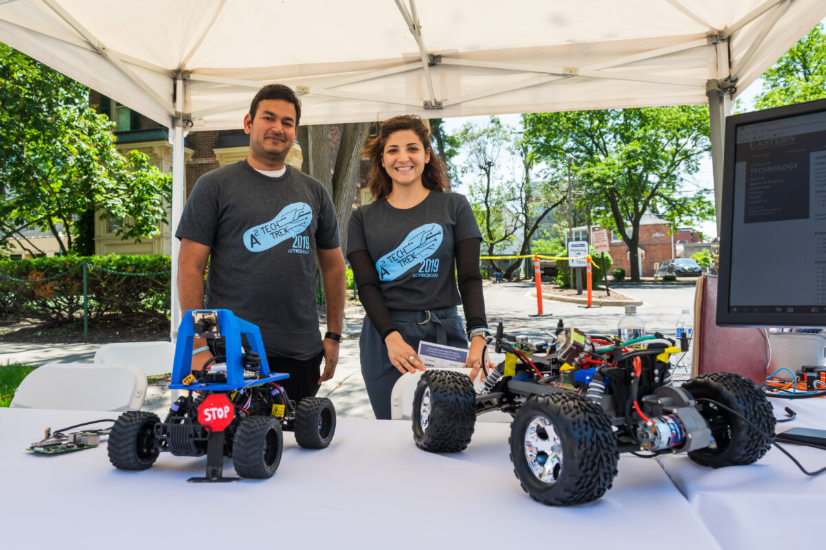 Man and woman with remote cars at Ann Arbor SPARK Tech Trek