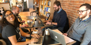 Four workers using laptops