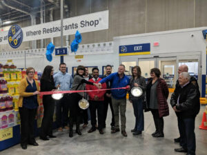 man cutting ribbon at Restaurant Depot grand opening event