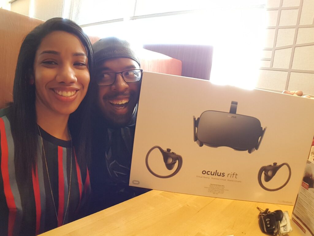 Man and woman smiling holding VR set
