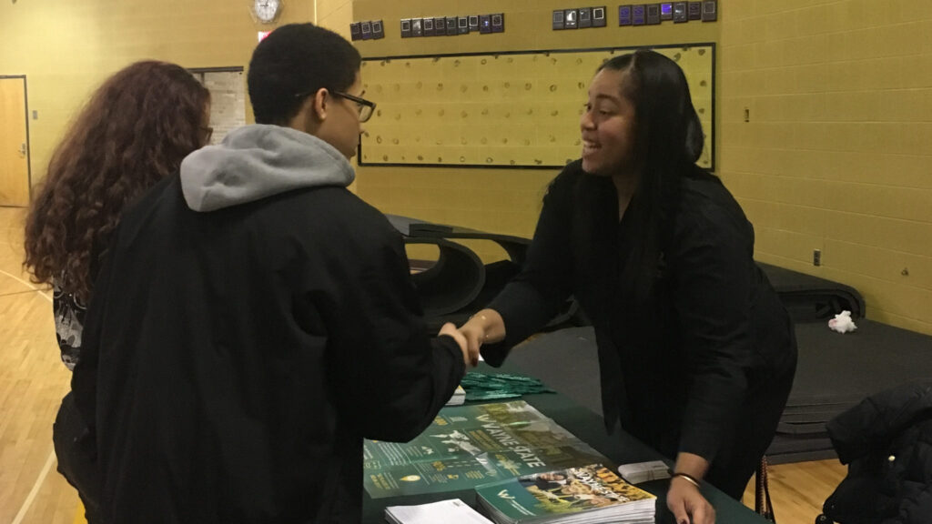 student and woman shaking hands at YCS College and Career Exploration Fair