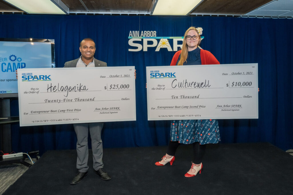 Helogenika and Culturewell accept checks from Ann Arbor SPARK-smaller version