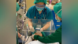 Surgeon intubating patient