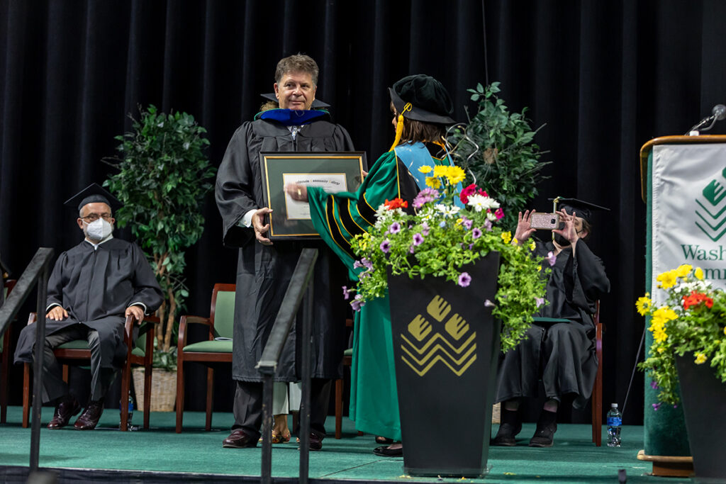 WCC President Dr. Rose B. Bellanca presents Ann Arbor SPARK President & CEO Paul Krutko with an Honorary Degree in Community Service prior to his address at the WCC Commencement Ceremony on Saturday, May 21. (Photo by JD Scott)