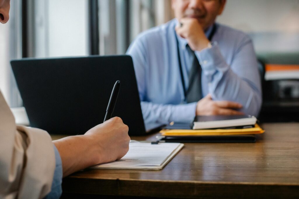 Two people working across from each other at a table.